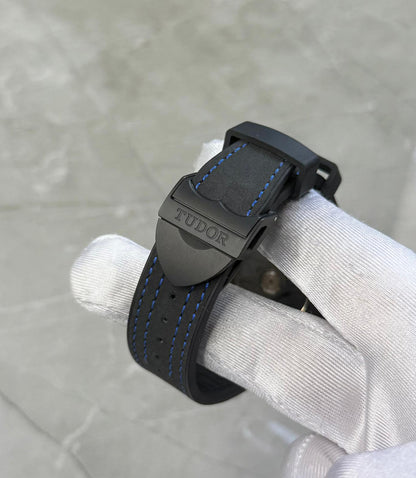 Tudor Black Bay Ceramic close-up of the dark branded buckle and blue-stitched black strap.