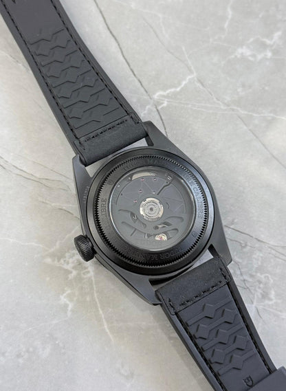 Tudor Black Bay Ceramic rear view showing the movement through the display caseback and patterned strap underside.
