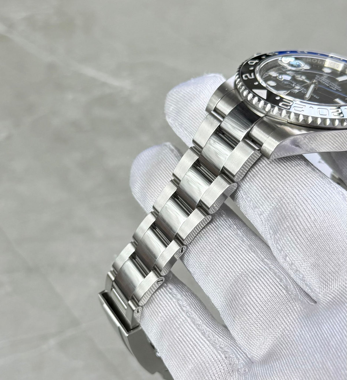 Rolex GMT-Master II Batman angled bracelet view with black bezel edge and case side visible.