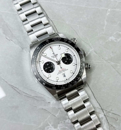 Tudor Black Bay Chronograph Panda lying flat with white dial, black subdials and black tachymeter bezel.