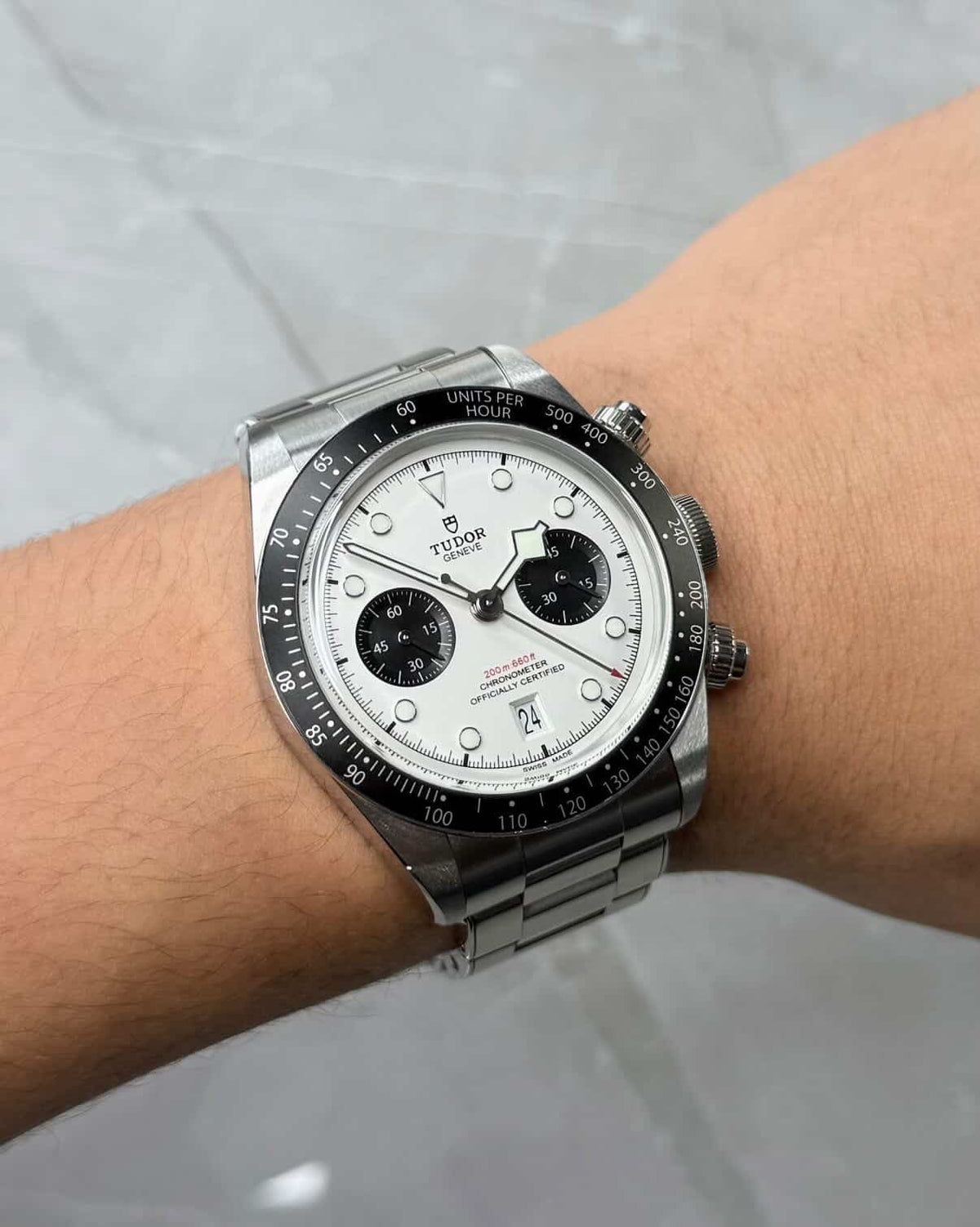Tudor Black Bay Chronograph Panda on wrist with white dial, black subdials and bracelet.