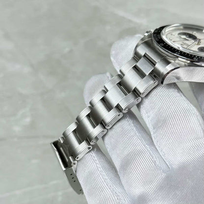 Tudor Black Bay Chronograph Panda bracelet close-up showing three-link construction and black bezel edge.