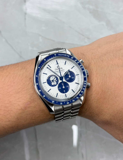 Omega Speedmaster Snoopy on wrist with pale dial, blue subdials and bracelet.