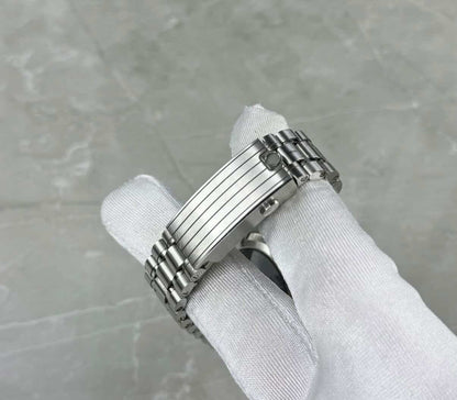 Omega Speedmaster Snoopy close-up of the ridged folding clasp and bracelet in a white glove.