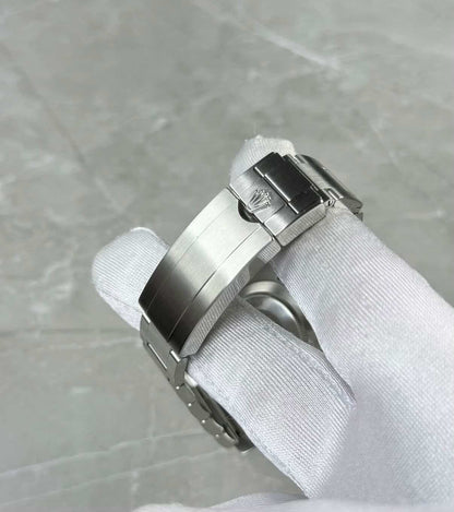 Rolex Submariner Date Hulk close-up of the folding clasp and crown emblem in a white glove.
