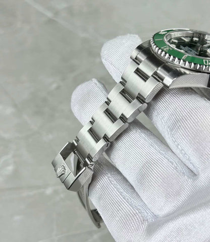 Rolex Submariner Date Hulk bracelet close-up showing three-link construction and the green bezel edge.