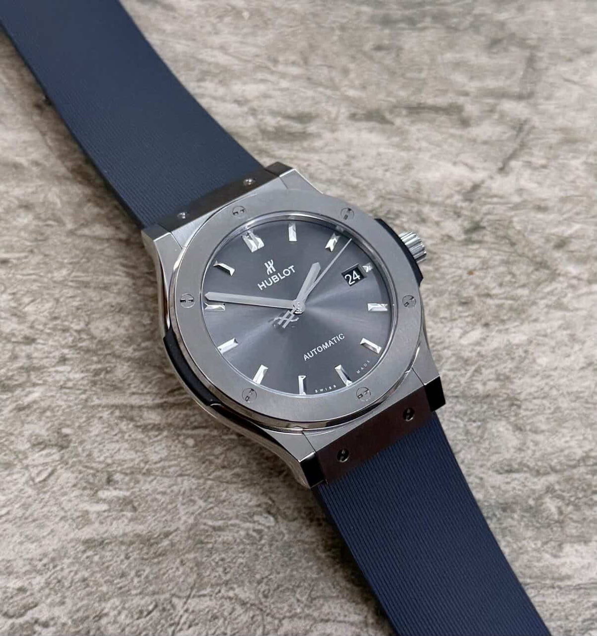 Hublot Classic Fusion lying flat with grey dial, date window and dark strap.