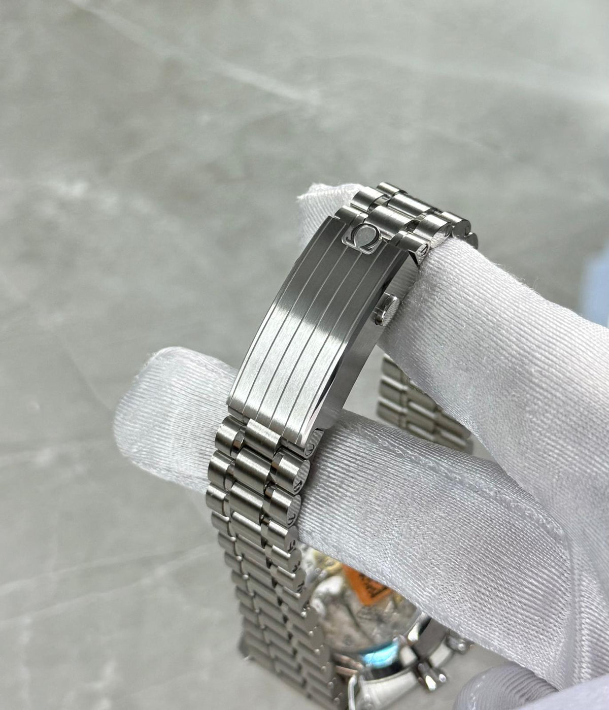Omega Speedmaster close-up of the ridged folding clasp and bracelet.