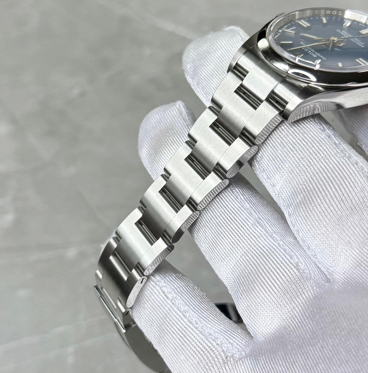 Rolex Oyster Perpetual 36 angled bracelet view showing three-link construction and smooth bezel.