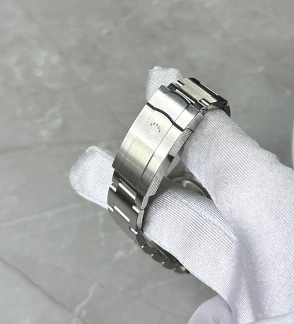 Rolex Oyster Perpetual 36 close-up of the folding clasp and bracelet held in a white glove.