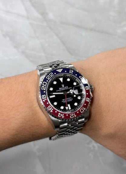 Rolex GMT-Master II Pepsi on wrist with red-and-blue bezel and five-link bracelet.