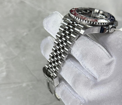 Rolex GMT-Master II Pepsi bracelet close-up showing narrow links, crown and the red bezel edge.
