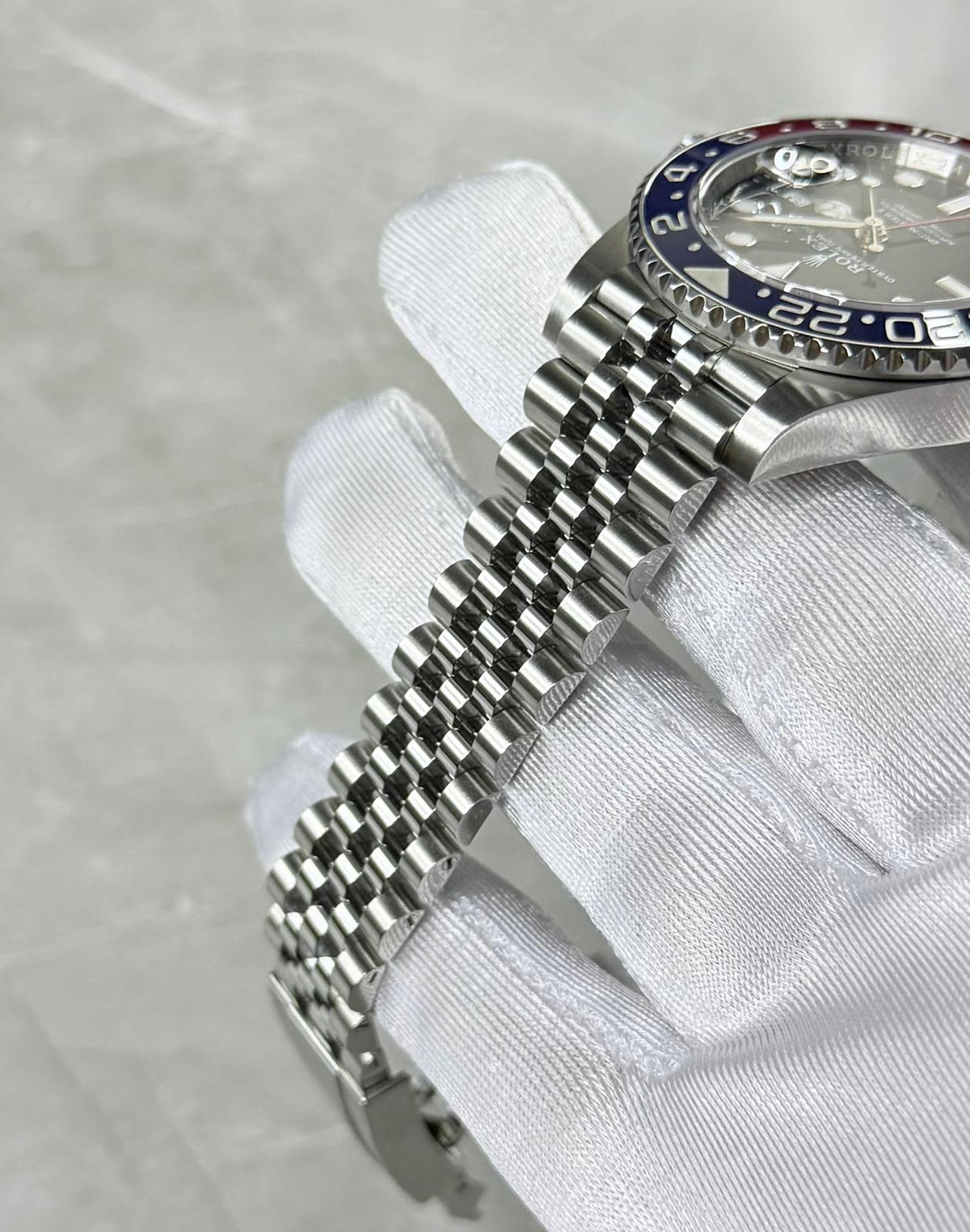 Rolex GMT-Master II Pepsi angled bracelet view showing five-link construction and blue bezel edge.