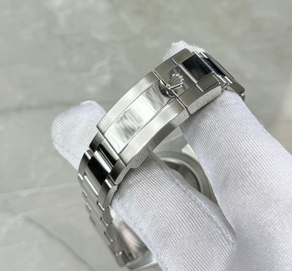 Rolex GMT-Master II Batman close-up of the crown-logo folding clasp and bracelet.